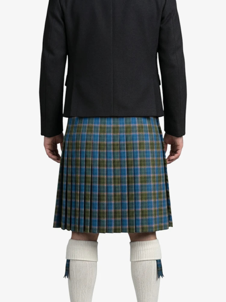 Person wearing a black jacket and blue plaid kilt on a white background