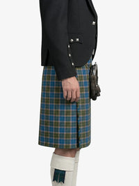 Person wearing a black jacket and green plaid kilt on a white background