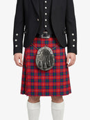 Person wearing a red tartan kilt with a black jacket on a white background
