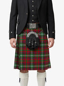 Person wearing a red plaid kilt with a black jacket on a white background