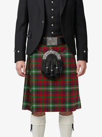Person wearing a red plaid kilt with a black jacket on a white background