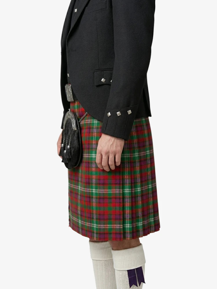 Person wearing a black jacket and red plaid kilt on a white background