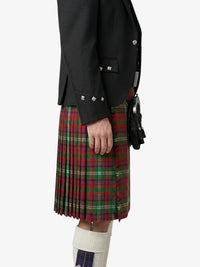 Person wearing a black jacket and red plaid kilt on a white background