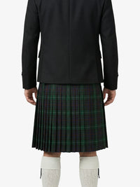 Person wearing a black coat and green plaid kilt on a white background