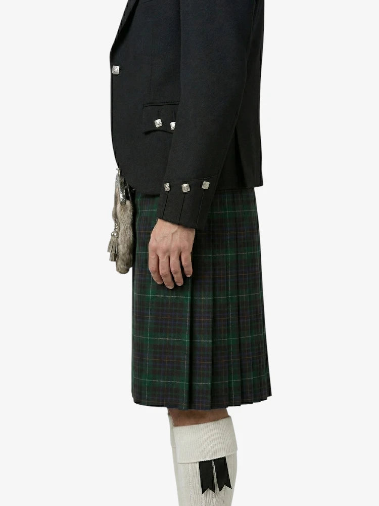 Person wearing a black jacket and green plaid kilt on a white background