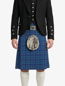 Person wearing a blue plaid kilt with a black jacket on a white background