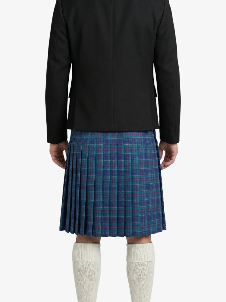 Person wearing a black blazer and blue plaid skirt on a white background