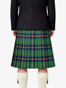 Person wearing a black jacket and green plaid kilt on a white background