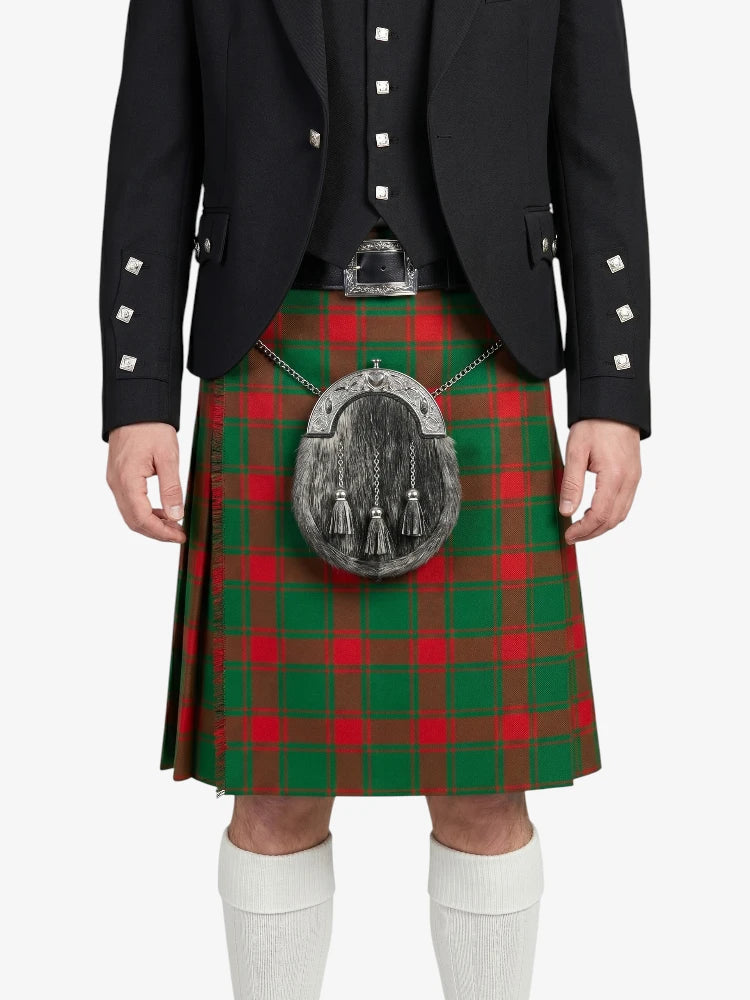 Person wearing a black jacket and red and green plaid kilt on a white background