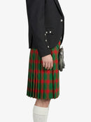 Person wearing a black jacket and green plaid kilt on a white background