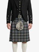 Person wearing a traditional Scottish kilt with a jacket on a white background
