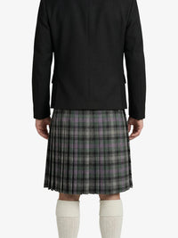 Person wearing a black jacket and plaid kilt on a white background