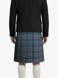 Person wearing a black coat and blue plaid kilt on a white background