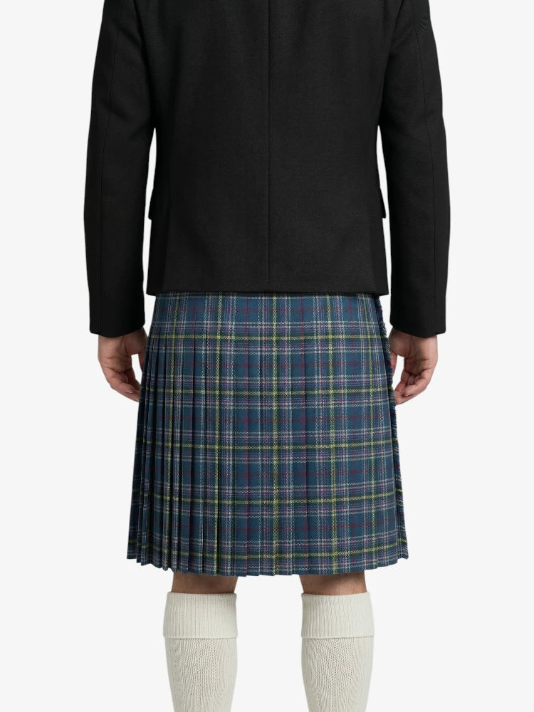 Person wearing a black coat and blue plaid kilt on a white background