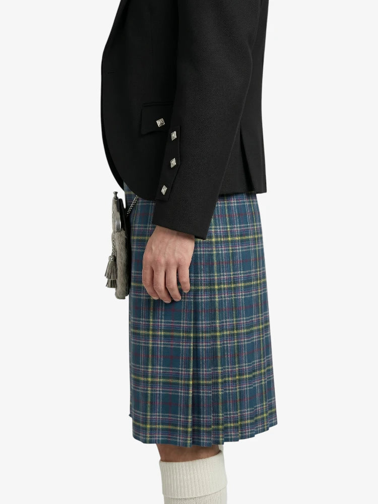 Person wearing a black jacket and blue plaid kilt on a white background