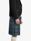 Person wearing a black blazer and blue plaid kilt on a white background
