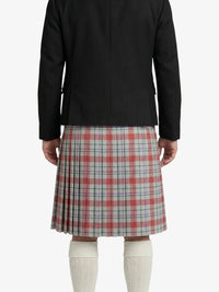 Person wearing a black jacket and plaid skirt on a white background