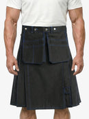 Person wearing a black kilt with white buttons on a plain background