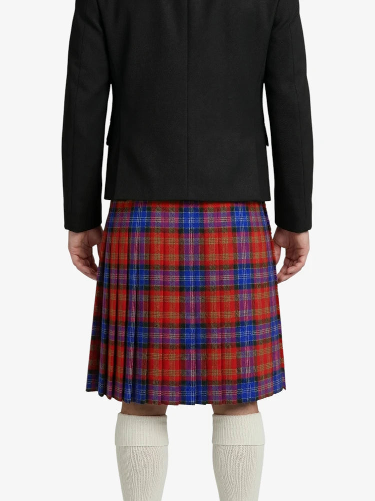 Person wearing a black blazer and red plaid kilt on a white background
