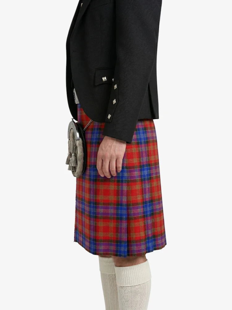 Person wearing a black jacket and red plaid kilt on a white background