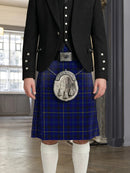 Person wearing a blue plaid kilt with a black jacket and white knee-high socks indoors.