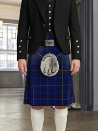 Person wearing a blue plaid kilt with a black jacket and white knee-high socks indoors.