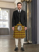 Man wearing a traditional Scottish kilt with a backdrop of a room with a window.