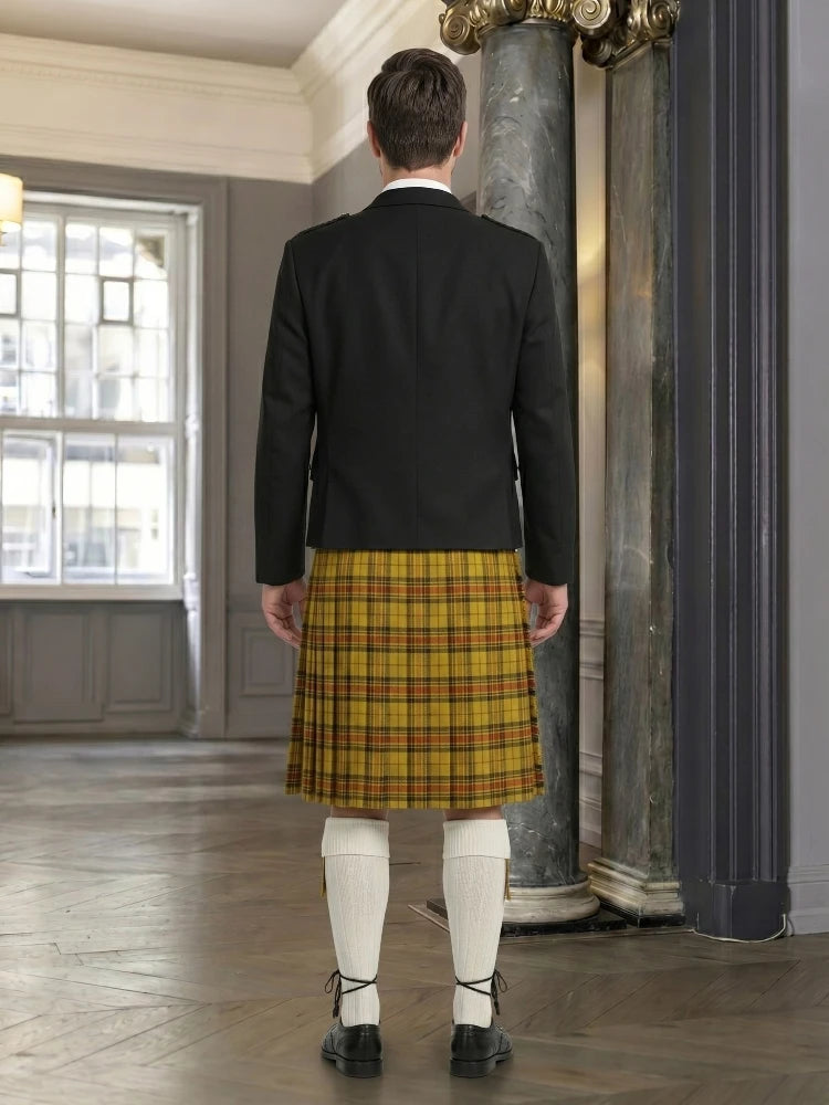 Man wearing a black jacket and yellow plaid kilt in an indoor setting.