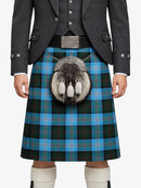 Person wearing a Scottish kilt with a tartan pattern on a white background