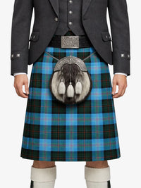 Person wearing a Scottish kilt with a tartan pattern on a white background