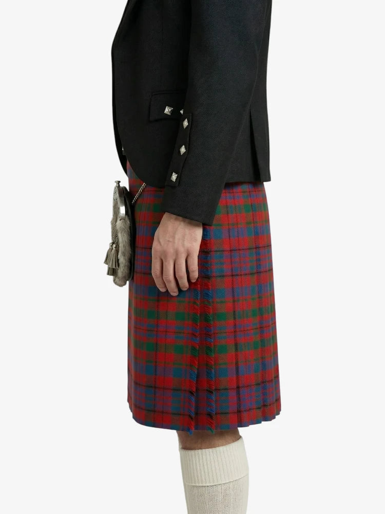 Person wearing a black jacket and red plaid kilt on a white background