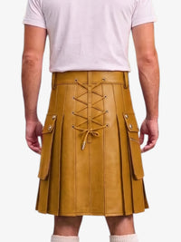 A mustard yellow faux-leather kilt with a lace-up front and side cargo pockets, shown on a model from the back wearing a light pink t-shirt.