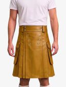 A mustard yellow faux-leather kilt with silver-tone double-breasted buttons and side flap pockets, shown on a model wearing a white t-shirt against a light gray background.