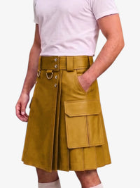A mustard yellow faux-leather kilt with a matching belt, silver-tone metal hardware, and cargo pockets, shown on a model wearing a white t-shirt against a light gray background.