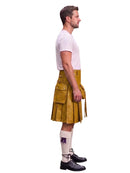 A man shown in profile wearing a mustard yellow leather kilt, a white t-shirt, white knee-high socks, and black leather shoes, isolated on a white background.