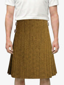 Person wearing a brown herringbone skirt on a white background