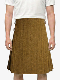 Person wearing a brown herringbone skirt on a white background