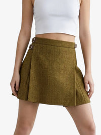 Green skirt worn by a person on a white background