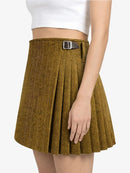 Brown pleated skirt with a silver buckle worn by a person on a white background