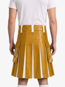 A mustard yellow faux-leather kilt with white vertical pleats and side cargo pockets, shown on a model from the back wearing a white t-shirt.