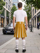 A man stands on a city sidewalk facing away from the camera, wearing a white short-sleeve T-shirt and a mustard yellow pleated kilt-style skirt with white vertical stripe panels, white knee-high socks, and black shoes. Storefronts, trees, a black car, and a bicycle are visible in the urban background.