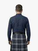 Man wearing a navy shirt and plaid kilt on a white background