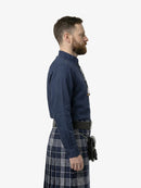 Man wearing a dark blue shirt and plaid kilt on a white background