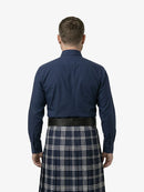 Man wearing a navy shirt and plaid kilt on a white background