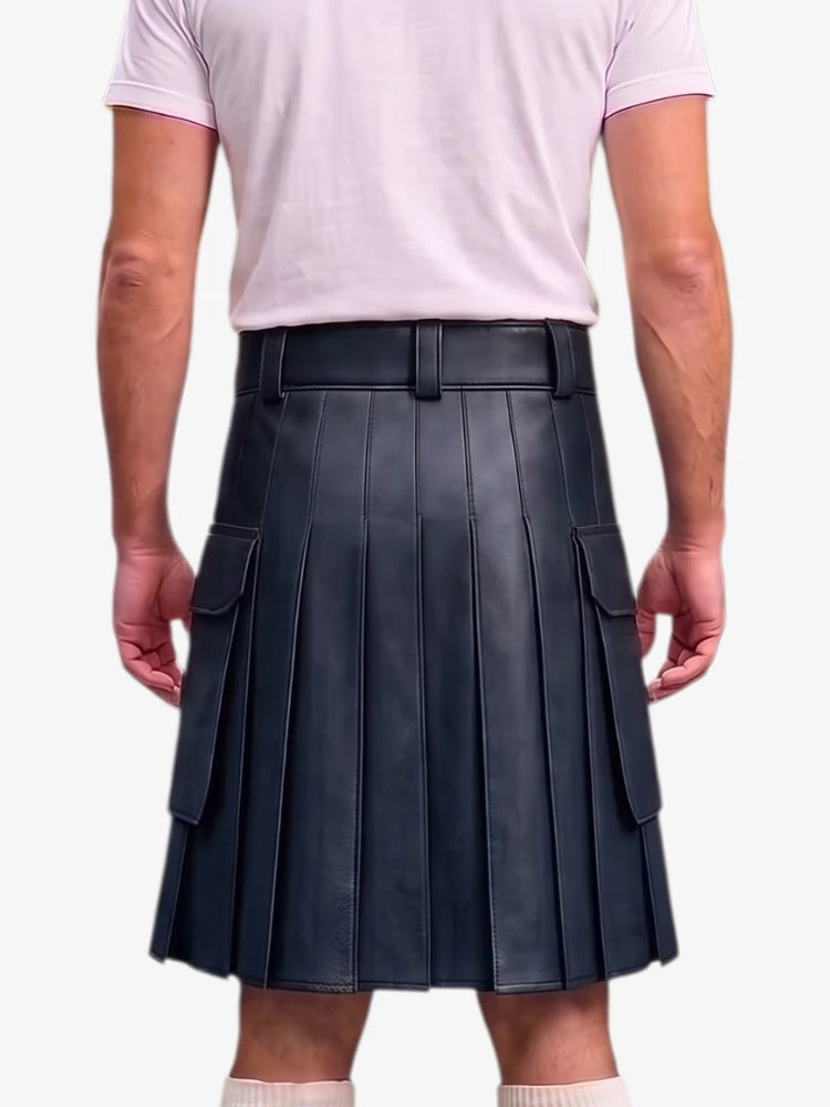 A person shown from the back wearing a black pleated leather kilt with side cargo pockets, paired with a light pink t-shirt and white socks, against a plain light gray background.