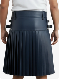 Person wearing a navy pleated skirt with black straps on a white background