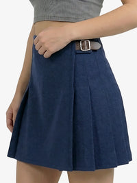 Navy blue pleated skirt worn by a person on a white background