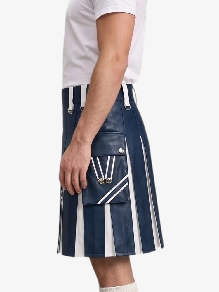 A person wearing a navy blue faux-leather kilt with bold white vertical stripes and silver hardware, paired with a white t-shirt, shown from the side against a light gray background.