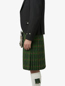 Person wearing a black jacket and green plaid kilt on a white background