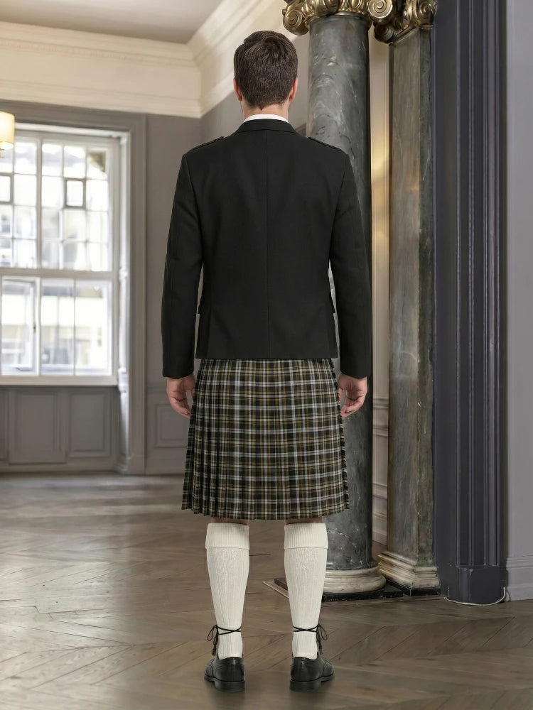 Man wearing a black jacket and plaid kilt in an elegant room with a large mirror.